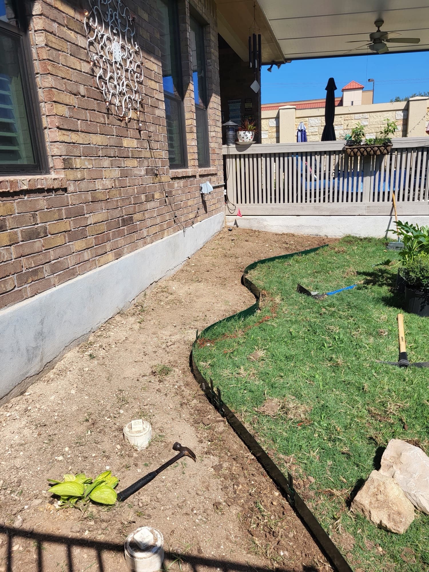 Plant bed with river rock installation