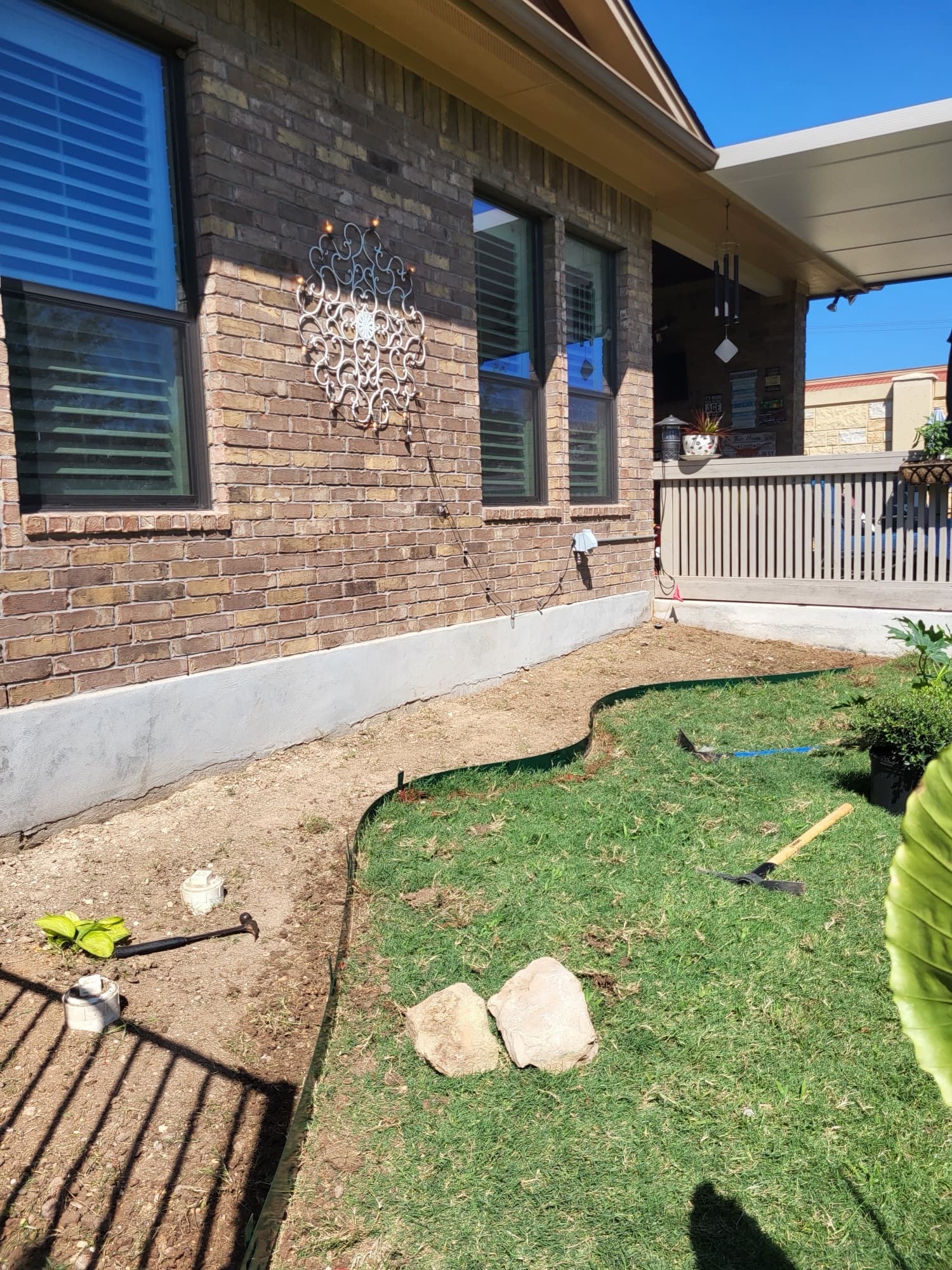 Plant bed with river rock installation