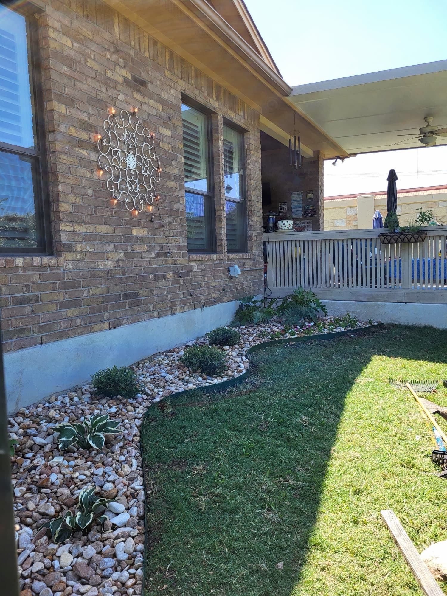 Plant bed with river rock installation